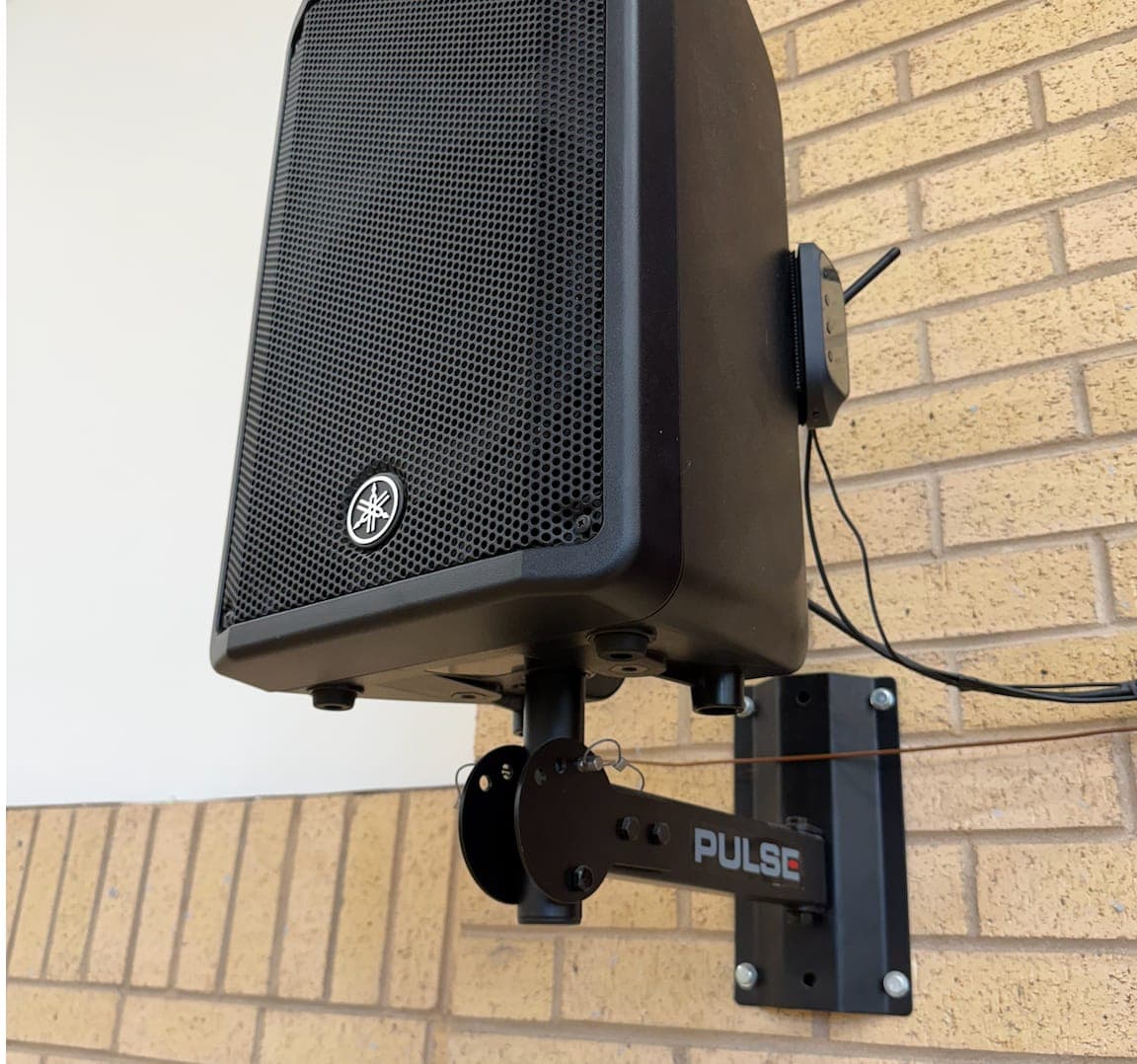Wall-mounted Yamaha speaker on a bracket