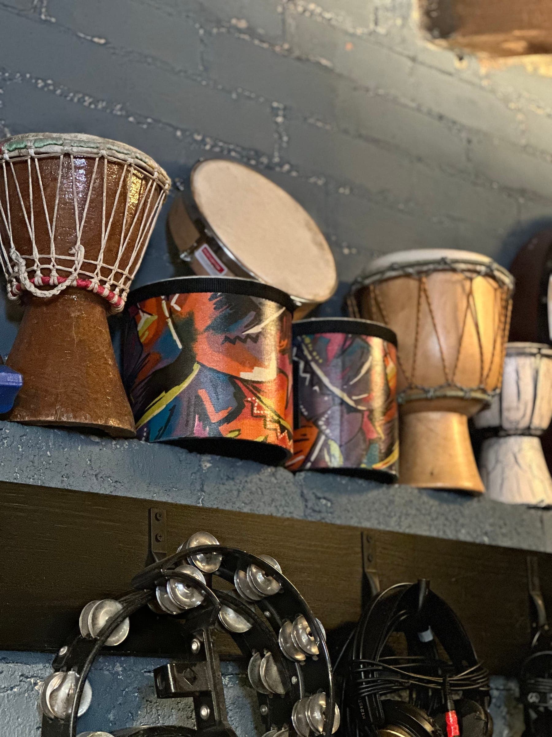 Djembes and hand percussion on a shelf