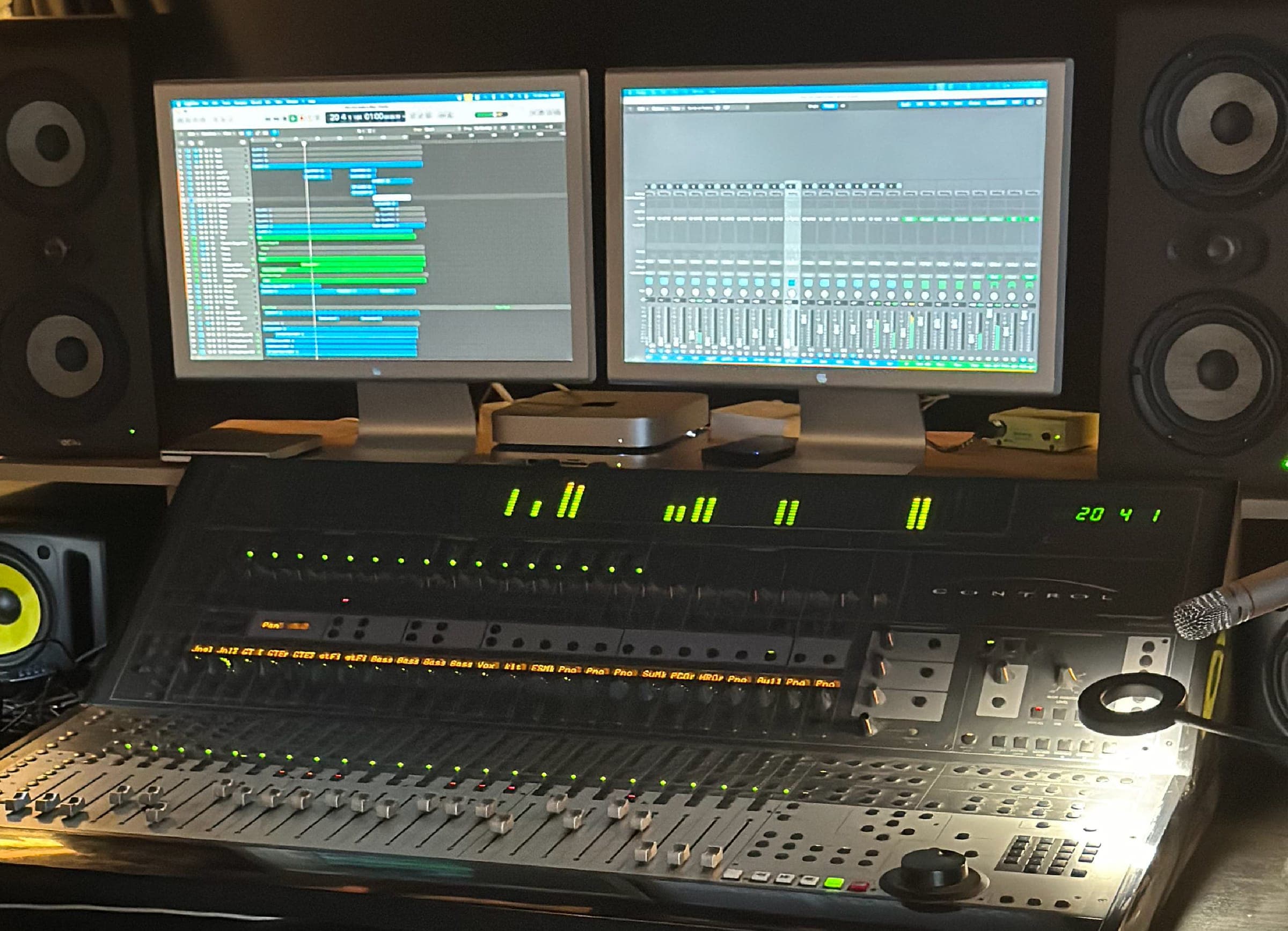 Mixing desk with studio monitors and session screens
