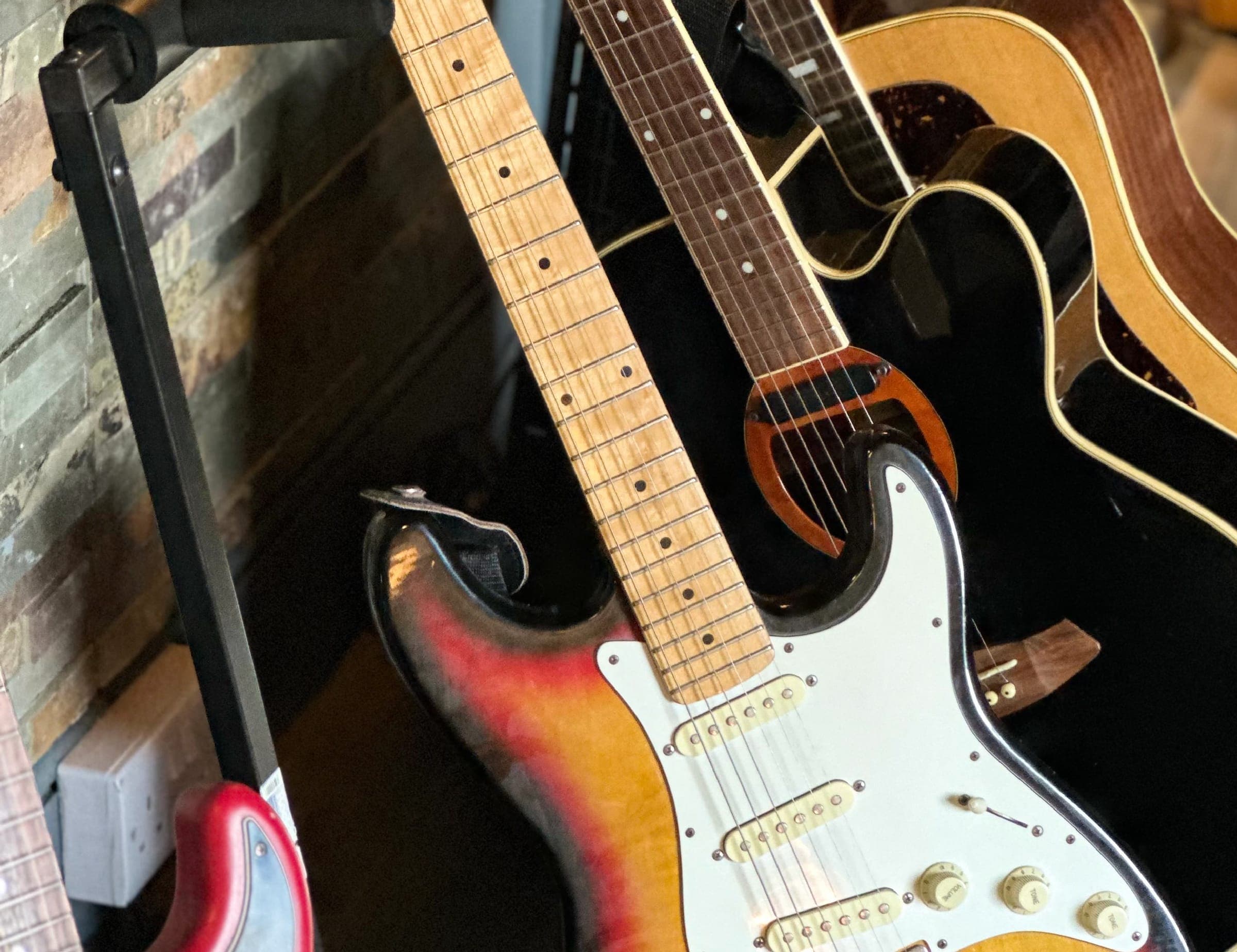 Electric and acoustic guitars on stands